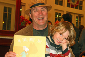 Author David E. Ray holds his new children's book, The Little Mouse Santi, as well as his main inspiration, his son Louis. Photo by David Lee Simmons with NOLA.com