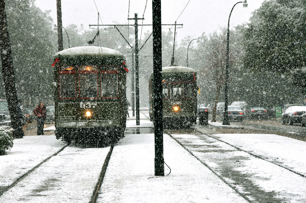 Snow falls over streetcars in New Orleans. Photo by Sally Asher.