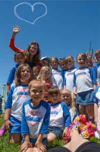 Photo of Katy and the Confetti Park Players at Jazz Fest, by Sally Asher (those are her feet in the foreground)