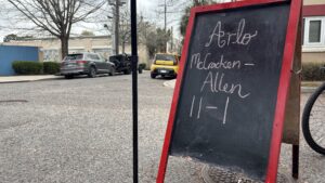 Sign in front of Bywater Bakery advertises 12 year old Arlo's performance