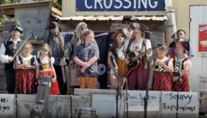 A group of pirates kids and adult are singing on a shanty stage. This is Louisiana kids music at its finest!